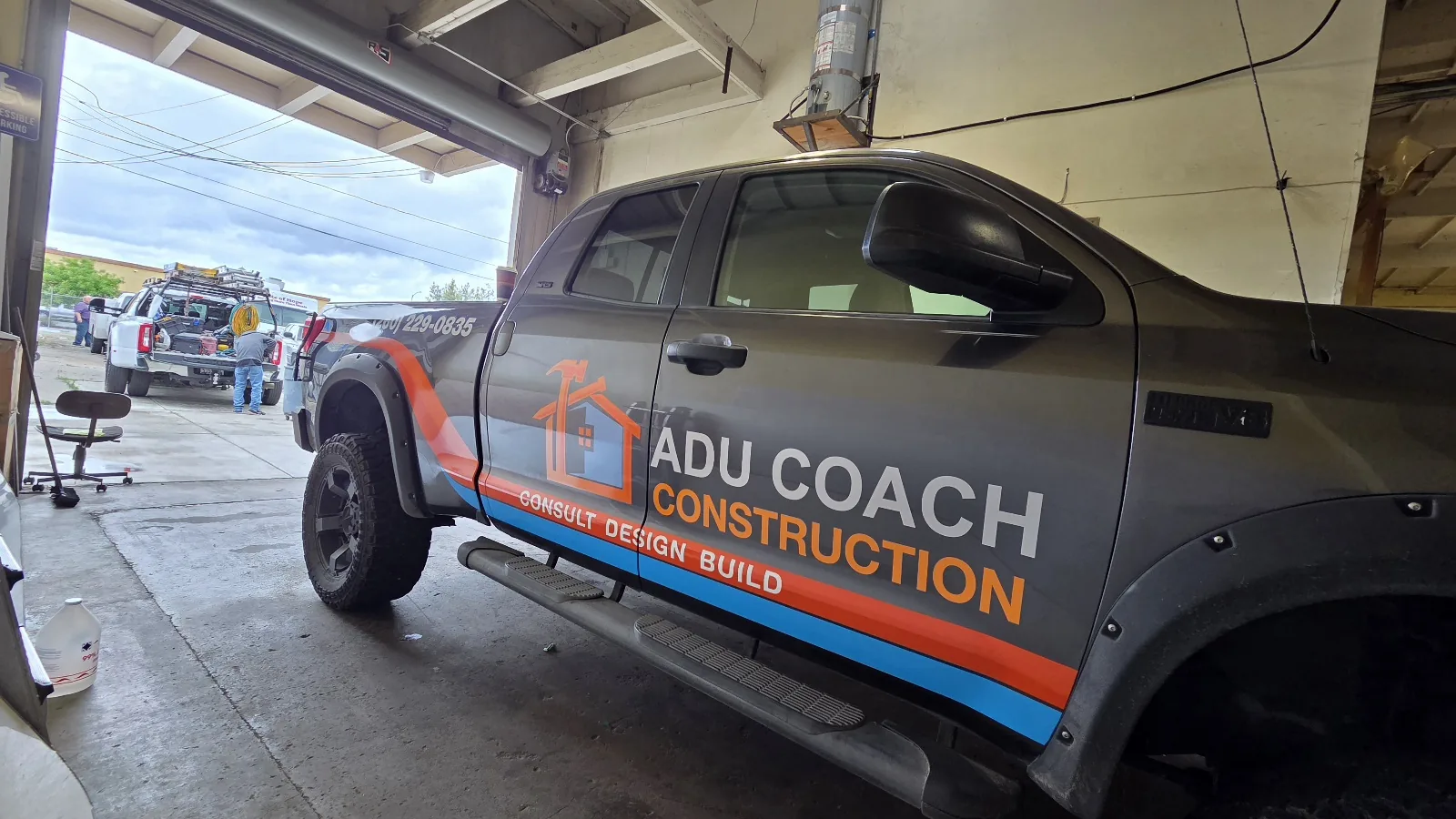ADU Coach Construction truck, partial wrap done inside the bay
