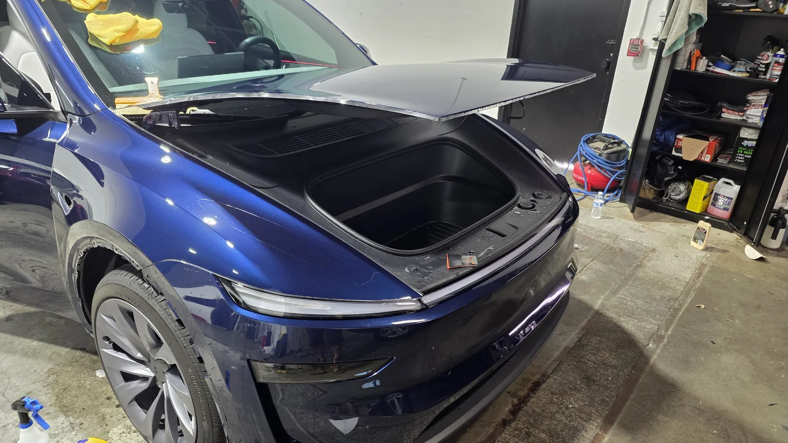 Tesla with the hood open during a film install